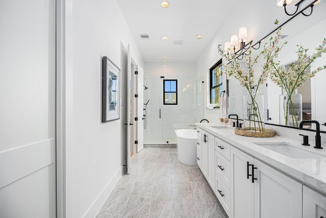 515 E 4th St, Houston, TX 77007 - bathroom featuring double vanity, a stall shower, a freestanding tub, recessed lighting, and marble finish floors