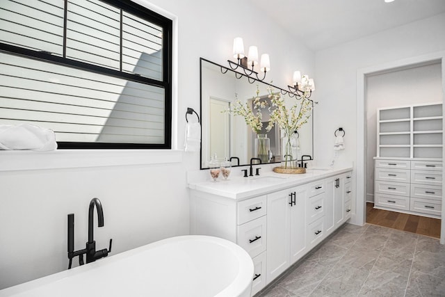 515 E 4th St, Houston, TX 77007 - full bathroom with a freestanding bath, double vanity, a chandelier, and a closet