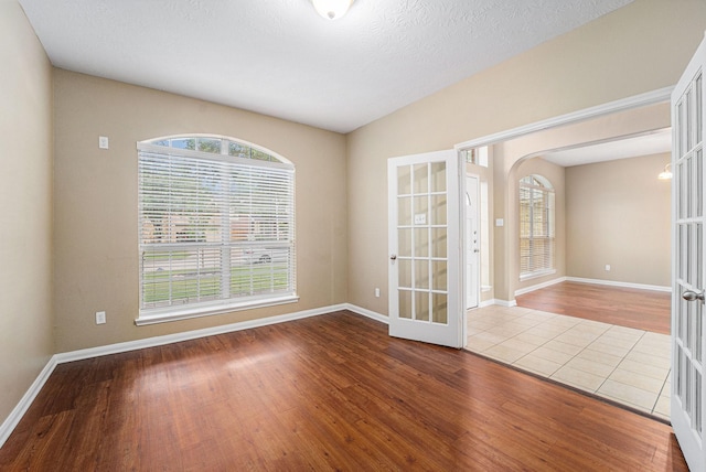 13707 Kingston River Ln, Houston, TX 77044 - unfurnished room featuring french doors, wood finished floors, and baseboards