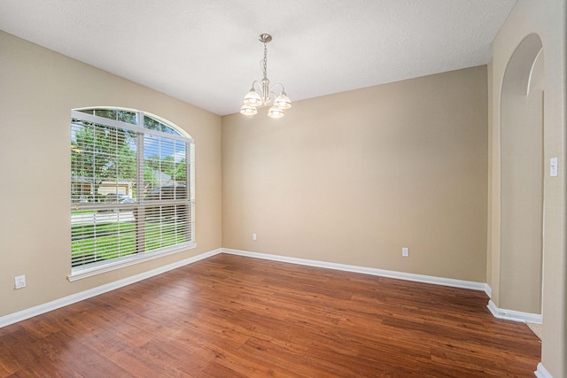 13707 Kingston River Ln, Houston, TX 77044 - spare room featuring a chandelier, wood finished floors, and baseboards