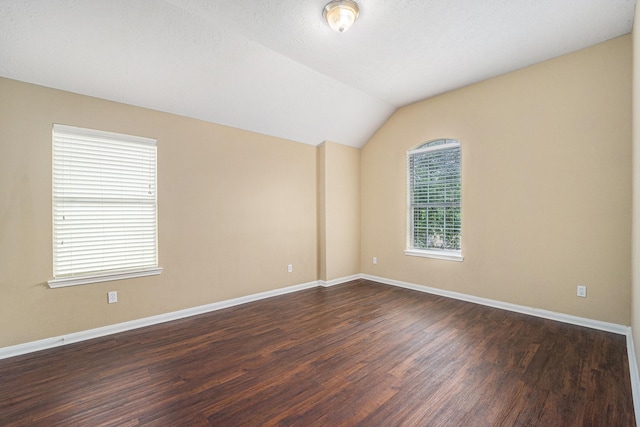 13707 Kingston River Ln, Houston, TX 77044 - unfurnished room featuring dark wood-style floors, baseboards, and lofted ceiling