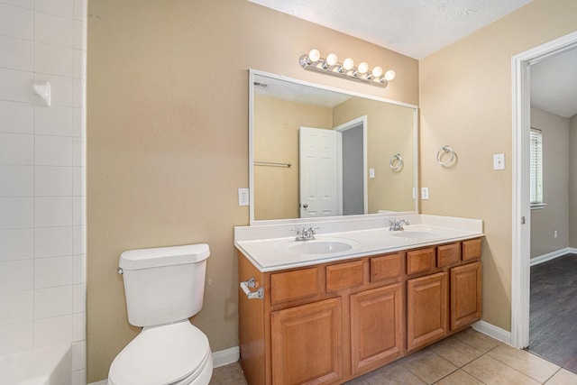 13707 Kingston River Ln, Houston, TX 77044 - full bath featuring double vanity, toilet, tile patterned flooring, and baseboards