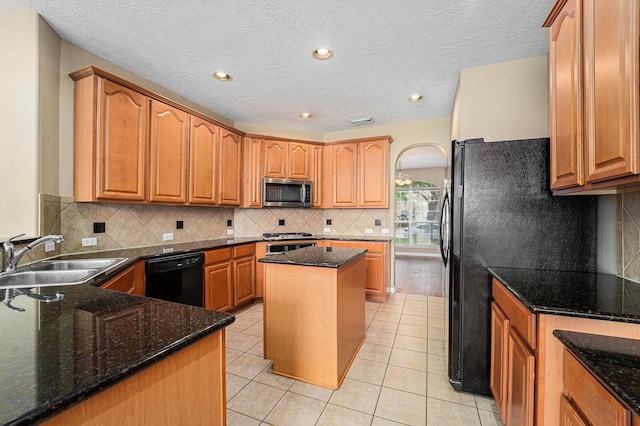 13707 Kingston River Ln, Houston, TX 77044 - kitchen with black appliances, a sink, tasteful backsplash, dark stone countertops, and light tile patterned flooring