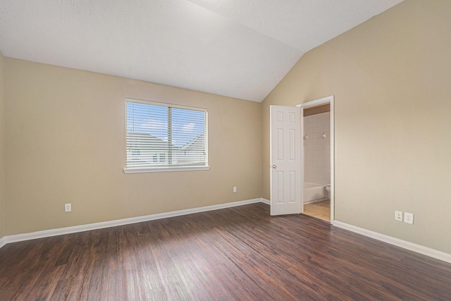 13707 Kingston River Ln, Houston, TX 77044 - empty room featuring wood finished floors, baseboards, and vaulted ceiling