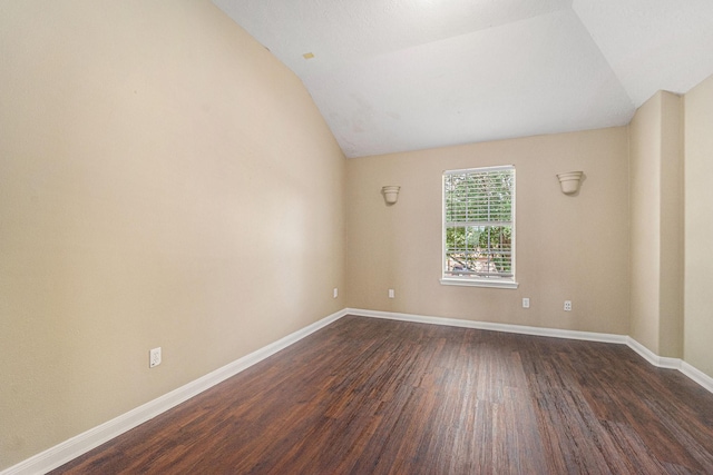 13707 Kingston River Ln, Houston, TX 77044 - empty room featuring dark wood-style flooring, vaulted ceiling, and baseboards