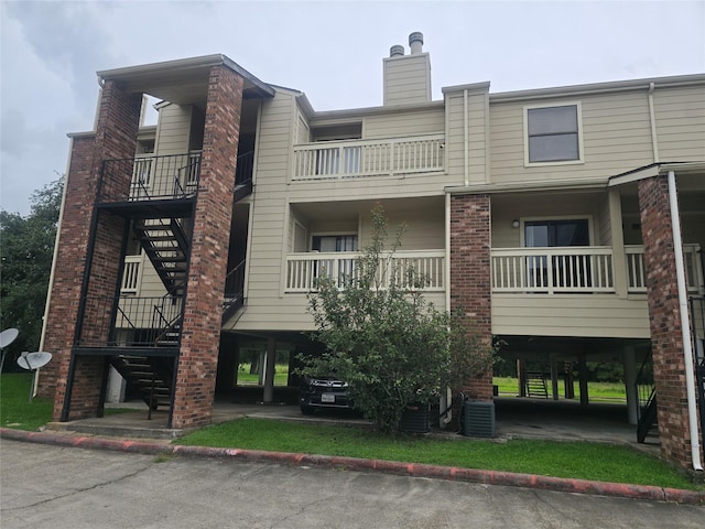 2501 Gulf Fwy Unit 249D, Dickinson, TX 77539 - view of building exterior with stairway and a carport