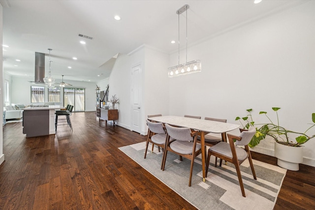 406 Welch St, Houston, TX 77006 - dining area with baseboards, dark wood-style flooring, ornamental molding, recessed lighting, and a ceiling fan