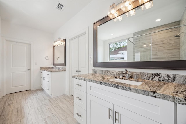 406 Welch St, Houston, TX 77006 - bathroom with a shower stall and two vanities