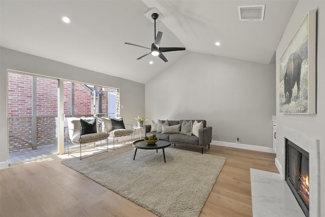 2829 Timmons Ln Unit 222, Houston, TX 77027 - living area with ceiling fan, a high end fireplace, lofted ceiling, light wood-type flooring, and recessed lighting
