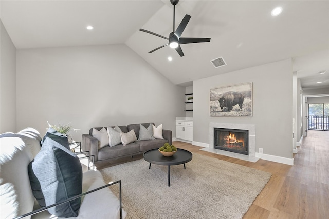 2829 Timmons Ln Unit 222, Houston, TX 77027 - living room featuring light wood-style flooring, a premium fireplace, a ceiling fan, recessed lighting, and lofted ceiling