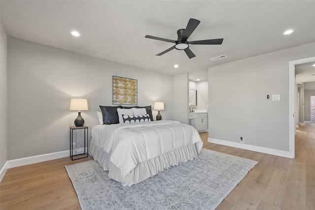 2829 Timmons Ln Unit 222, Houston, TX 77027 - bedroom featuring baseboards, light wood finished floors, recessed lighting, ensuite bathroom, and a ceiling fan