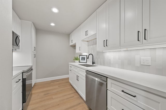 2829 Timmons Ln Unit 222, Houston, TX 77027 - kitchen with stainless steel appliances, a sink, baseboards, light countertops, and recessed lighting