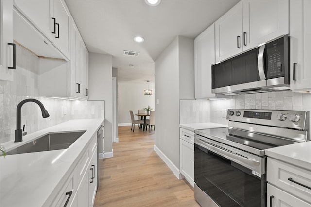 2829 Timmons Ln Unit 222, Houston, TX 77027 - kitchen with appliances with stainless steel finishes, a sink, decorative backsplash, recessed lighting, and light countertops
