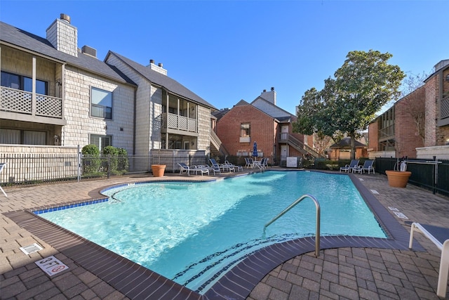 2829 Timmons Ln Unit 222, Houston, TX 77027 - community pool featuring a residential view and a patio area