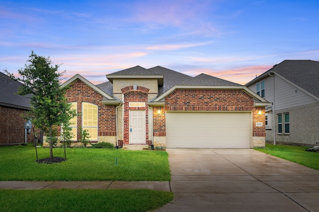 5323 Camerford Ct, Alvin, TX 77511 - view of front of property featuring brick siding, roof with shingles, driveway, an attached garage, and a yard