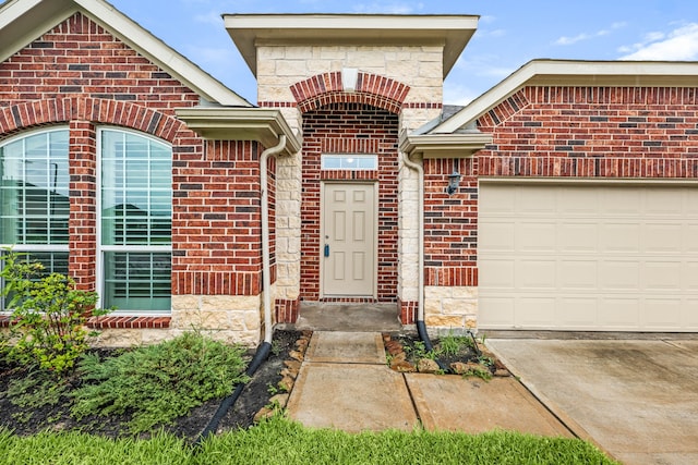 5323 Camerford Ct, Alvin, TX 77511 - entrance to property featuring a garage, brick siding, stone siding, and concrete driveway