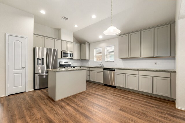 5323 Camerford Ct, Alvin, TX 77511 - kitchen with stainless steel appliances, lofted ceiling, gray cabinets, dark wood-type flooring, and recessed lighting