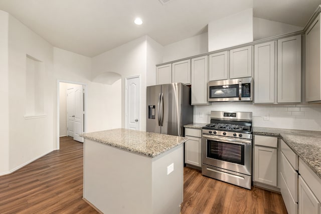 5323 Camerford Ct, Alvin, TX 77511 - kitchen with stainless steel appliances, dark wood-style flooring, a center island, arched walkways, and recessed lighting