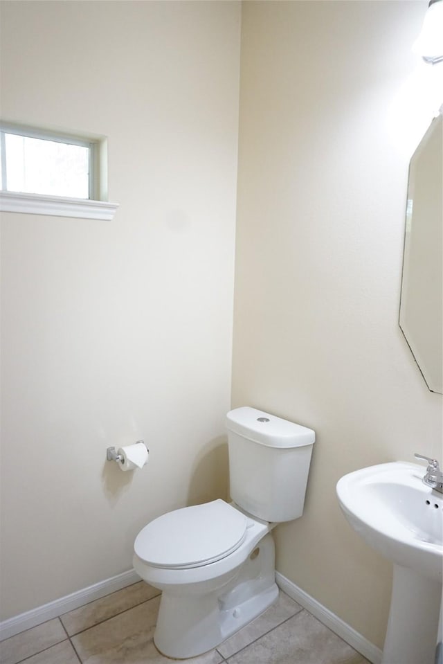 1608 Grable Cove Ln, Spring, TX 77379 - bathroom featuring toilet, tile patterned flooring, and baseboards