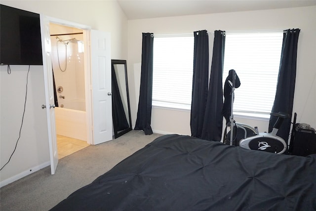 1608 Grable Cove Ln, Spring, TX 77379 - bedroom with light colored carpet, connected bathroom, vaulted ceiling, and baseboards