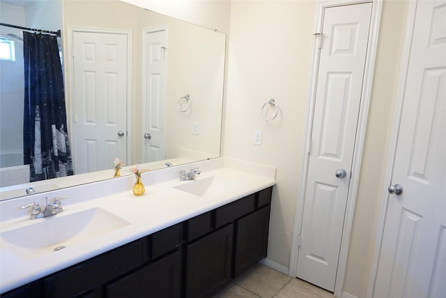 1608 Grable Cove Ln, Spring, TX 77379 - bathroom featuring double vanity, tile patterned floors, a shower with curtain, and baseboards