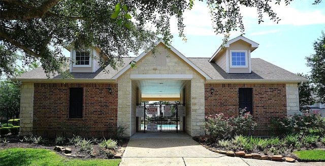 1608 Grable Cove Ln, Spring, TX 77379 - view of front of home featuring stone siding, brick siding, and a shingled roof