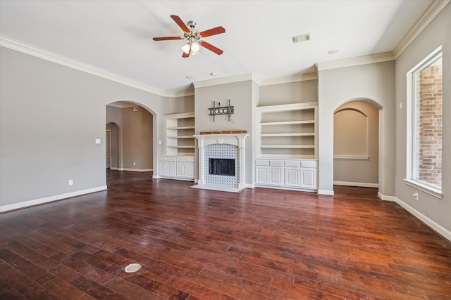 2703 Kestrel Trace Ln, Katy, TX 77494 - unfurnished living room with ceiling fan, crown molding, baseboards, arched walkways, and built in shelves
