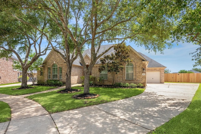 2703 Kestrel Trace Ln, Katy, TX 77494 - traditional-style home featuring concrete driveway, an attached garage, brick siding, and roof with shingles