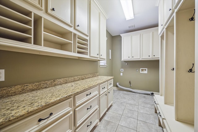 2703 Kestrel Trace Ln, Katy, TX 77494 - washroom with hookup for a washing machine, cabinet space, light tile patterned floors, gas dryer hookup, and baseboards
