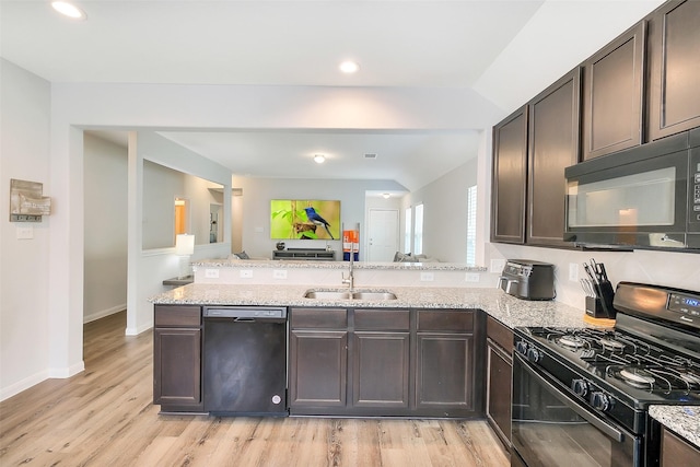 23607 Buttress Root Dr, Spring, TX 77373 - kitchen with black appliances, a sink, a peninsula, dark brown cabinetry, and recessed lighting