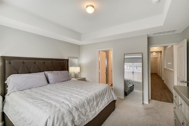 23607 Buttress Root Dr, Spring, TX 77373 - bedroom featuring a raised ceiling, light colored carpet, and baseboards
