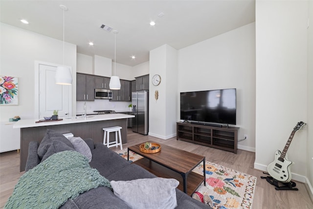 6307 Chelsea Falls Ln, Houston, TX 77008 - living area with baseboards, light wood-style flooring, recessed lighting, and radiator