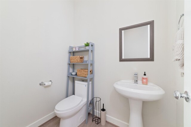 6307 Chelsea Falls Ln, Houston, TX 77008 - bathroom with baseboards, toilet, and wood finished floors