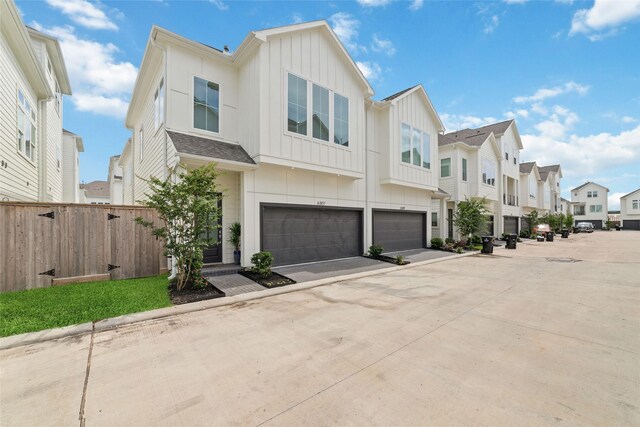 6307 Chelsea Falls Ln, Houston, TX 77008 - townhome / multi-family property featuring a residential view, board and batten siding, a garage, and driveway