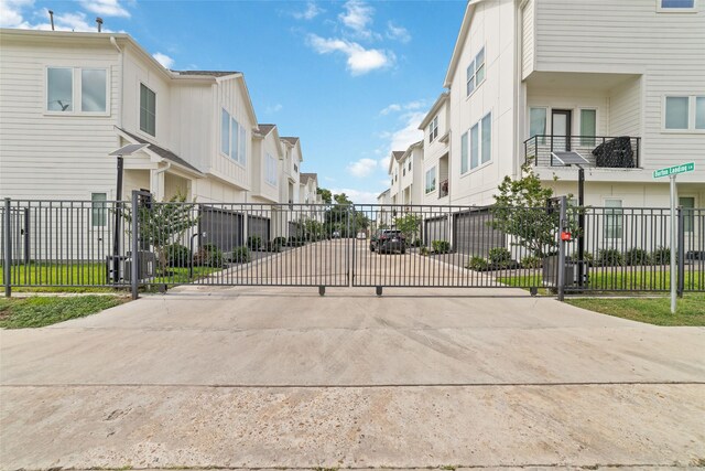 6307 Chelsea Falls Ln, Houston, TX 77008 - view of concrete road with a residential view and a gate