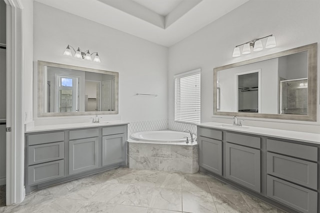 13303 Itasca Pine Dr, Humble, TX 77346 - full bathroom featuring two vanities, a bath, marble look tile flooring, and a stall shower