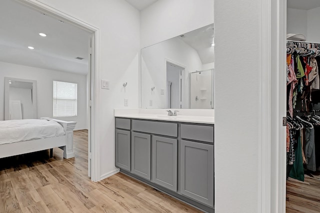 4818 Penton Meadow Ln, Rosharon, TX 77583 - bathroom featuring a spacious closet, a shower stall, ensuite bathroom, wood finished floors, and recessed lighting