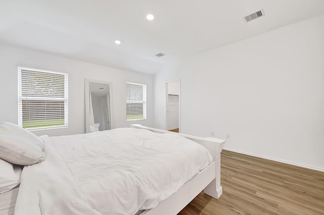 4818 Penton Meadow Ln, Rosharon, TX 77583 - bedroom with multiple windows, light wood-type flooring, baseboards, and recessed lighting