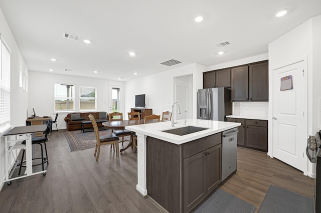 21746 Heather Elm Dr, Cypress, TX 77433 - kitchen featuring stainless steel appliances, a sink, dark brown cabinetry, dark wood finished floors, and light countertops