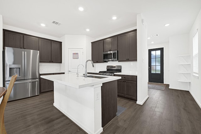 21746 Heather Elm Dr, Cypress, TX 77433 - kitchen with appliances with stainless steel finishes, a sink, dark brown cabinetry, light countertops, and backsplash