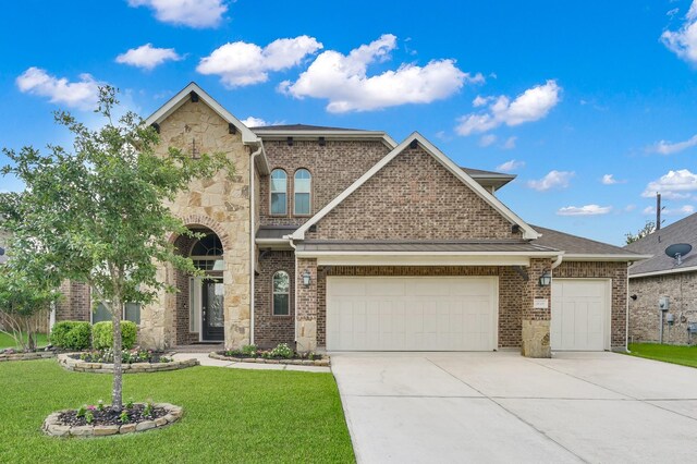 5015 Gold Lantana Trl, Spring, TX 77389 - view of front of house with a garage, stone siding, driveway, a front yard, and brick siding