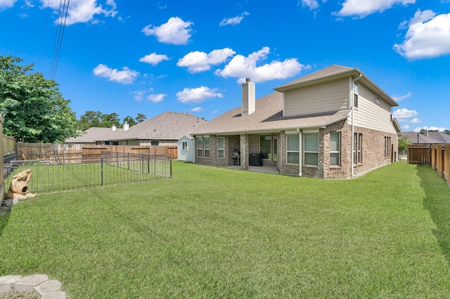5015 Gold Lantana Trl, Spring, TX 77389 - back of house with a chimney, brick siding, a patio area, roof with shingles, and a shed