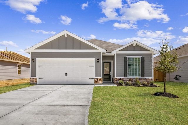10347 Red Cardinal Dr, Cleveland, TX 77328 - view of front of property featuring stone siding, concrete driveway, board and batten siding, and a front lawn