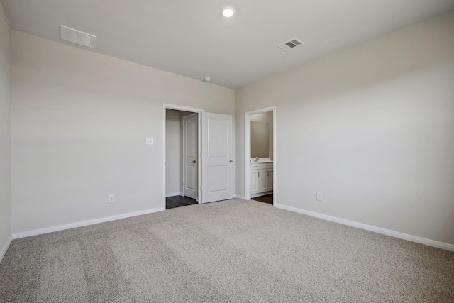 10347 Red Cardinal Dr, Cleveland, TX 77328 - unfurnished bedroom featuring dark colored carpet, baseboards, recessed lighting, and connected bathroom