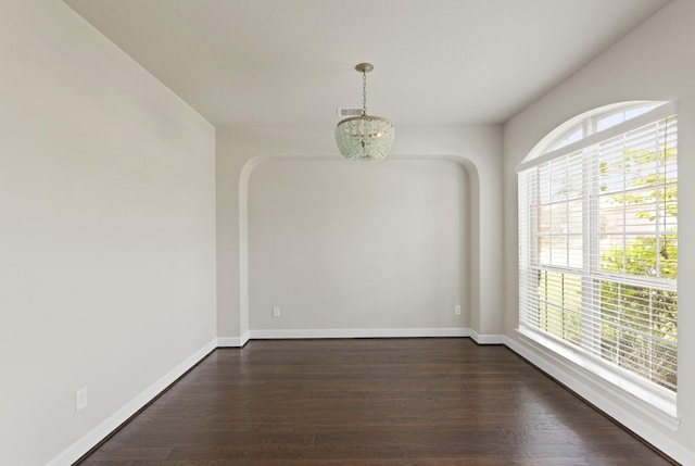 2131 Cranbrook Ridge Ln, Sugar Land, TX 77479 - empty room with dark wood finished floors, baseboards, and arched walkways