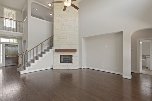 2131 Cranbrook Ridge Ln, Sugar Land, TX 77479 - unfurnished living room with high vaulted ceiling, ceiling fan, arched walkways, stairway, and a fireplace