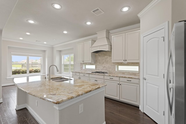 2131 Cranbrook Ridge Ln, Sugar Land, TX 77479 - kitchen featuring stainless steel appliances, custom range hood, a sink, crown molding, and recessed lighting
