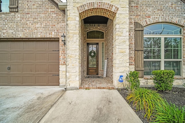 18610 Fairmont Springs Ct, Cypress, TX 77429 - property entrance with stone siding, brick siding, an attached garage, and concrete driveway