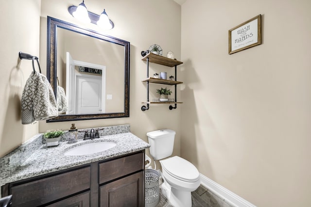 18610 Fairmont Springs Ct, Cypress, TX 77429 - bathroom with baseboards, vanity, toilet, and wood finished floors