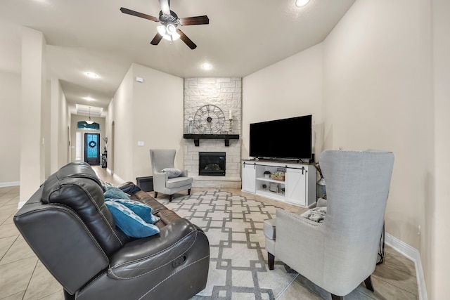 18610 Fairmont Springs Ct, Cypress, TX 77429 - living area featuring a ceiling fan, baseboards, a stone fireplace, recessed lighting, and light tile patterned flooring